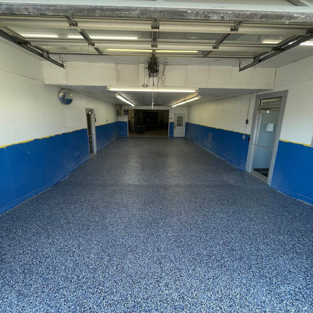 Finished blue and gray full-flake epoxy floor coating in a commercial garage in the Kansas City metro
