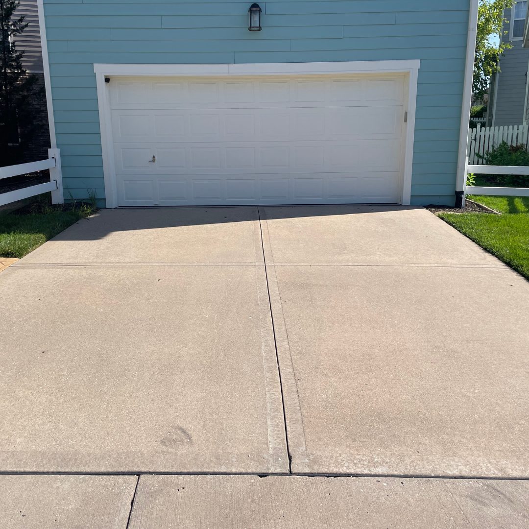 Concrete driveway in Lees Summit, MO after pressure washing and sealing