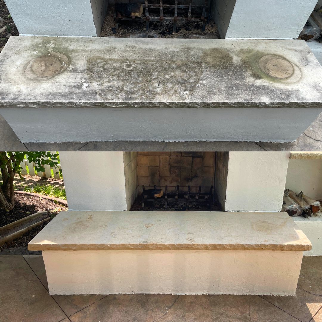 Before and after pressure washing of an outdoor fireplace stone cap in Lees Summit, MO, moss and grime removed to reveal the natural stone