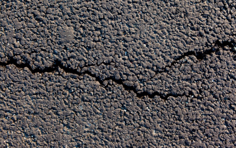 Driveway cracks being filled with hot pour crack filler in Kansas City